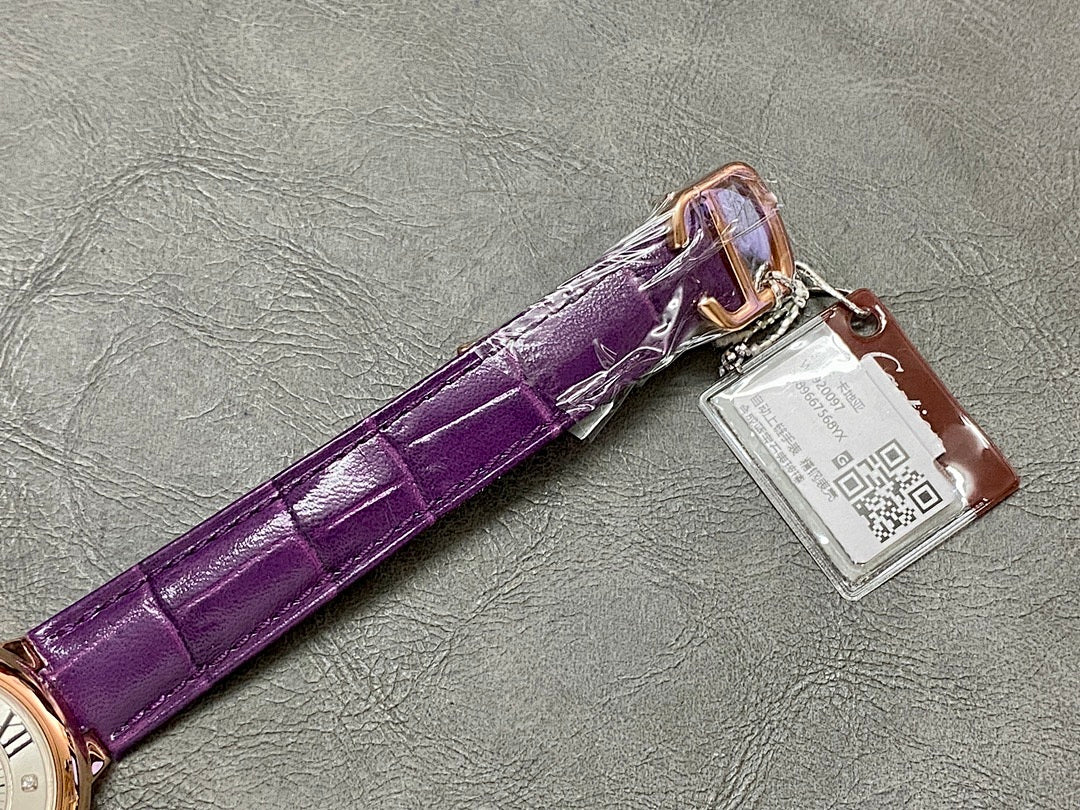 Cartier watch with purple leather strap, metal clasp, and attached tag.