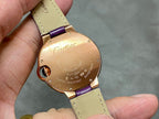 Cartier oval watch case back with purple strap, engraved details on gold-tone round back.