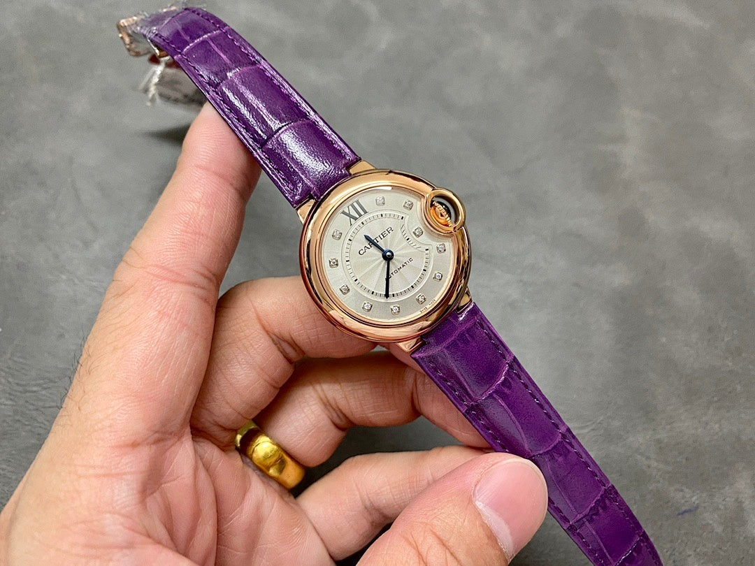 Cartier oval watch on purple leather strap, gold-tone case, cream dial with Roman numerals.