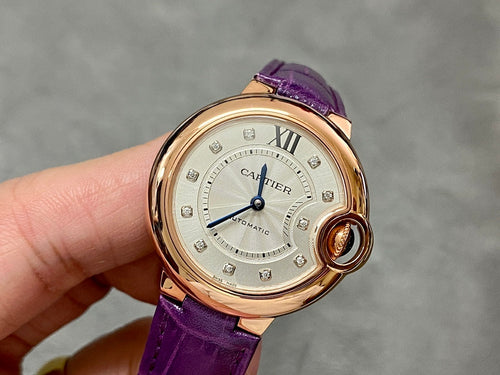Cartier oval watch with purple leather strap, gold-tone case, cream dial and Roman numerals.