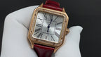 Cartier watch with gold-toned case, diamond-like bezel, red leather strap