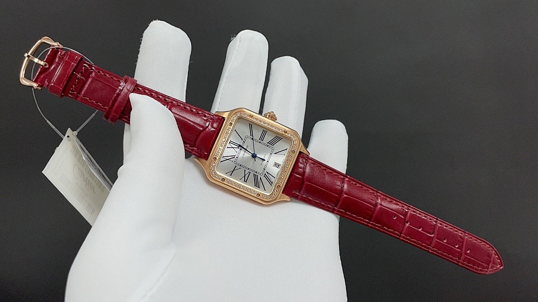 Cartier watch with red leather strap and gold-toned case on white gloves