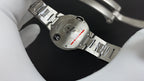 Stainless steel wristwatch bracelet and caseback detail, with crown and screws