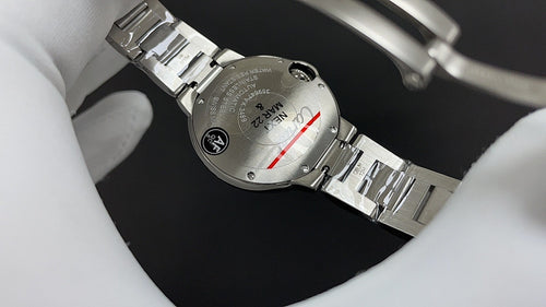 Stainless steel wristwatch bracelet and caseback detail, with crown and screws