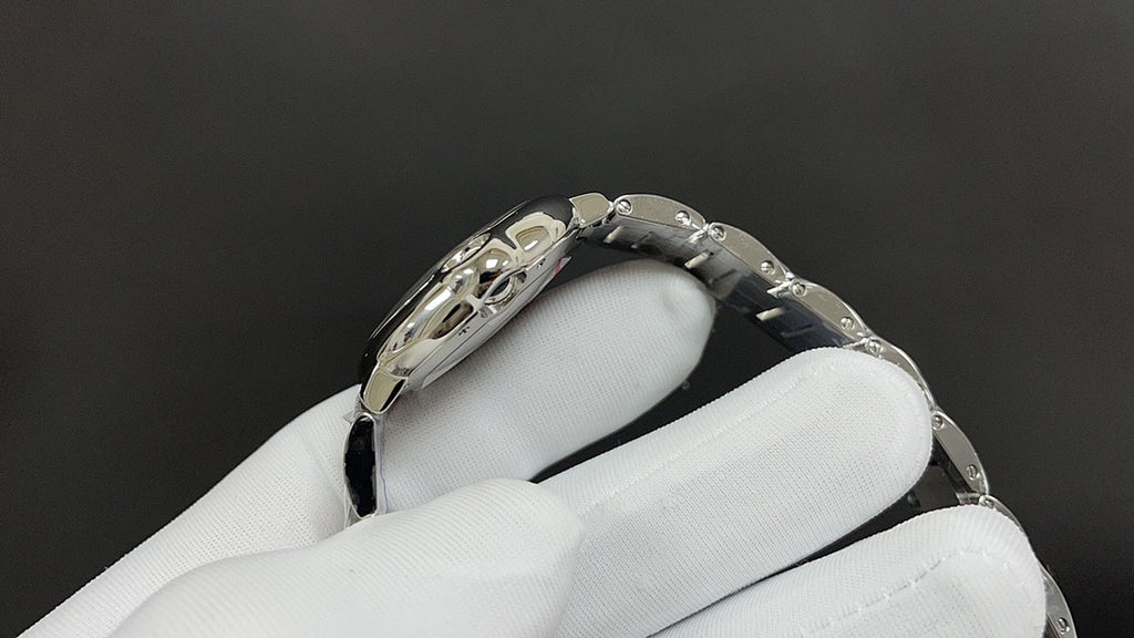 Stainless steel wristwatch with bracelet links and round bezel, side angle