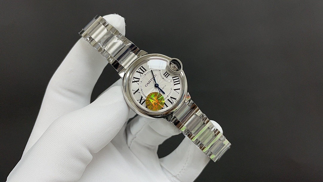 Stainless steel wristwatch with white dial and bracelet detail, angled profile