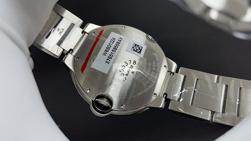 Wristwatch case underside and bracelet, metal links with serial text and inspection opening