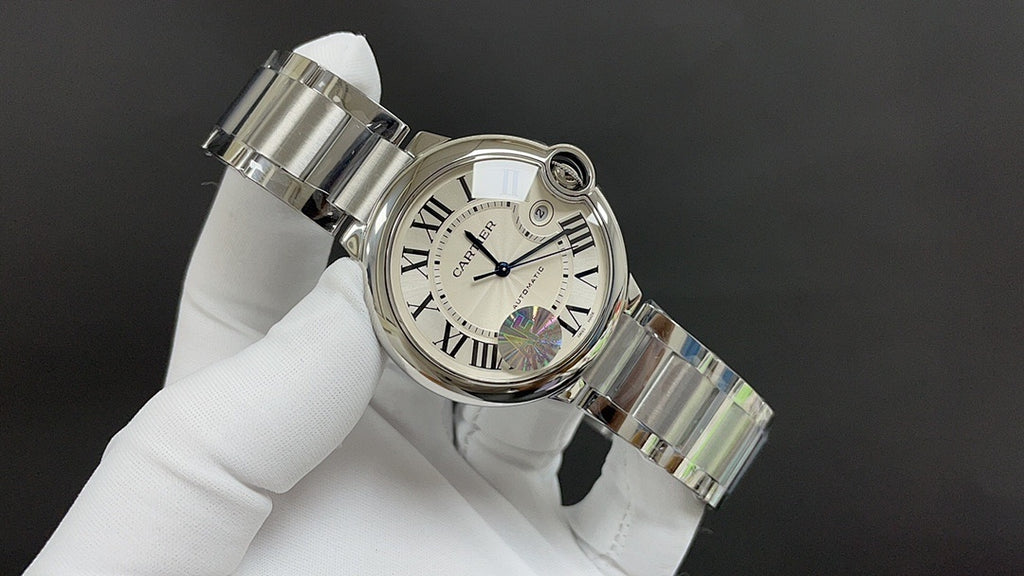 Wristwatch angled view, silver metal bracelet links and Roman numeral dial on white glove