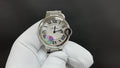 Cartier wristwatch with silver-tone case, Roman numeral dial, and round crown