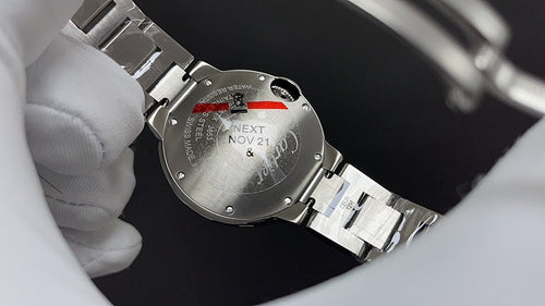 Cartier wristwatch caseback with stainless-steel bracelet and engraved back text