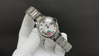 Cartier wristwatch angled view with metal bracelet and round bezel detail