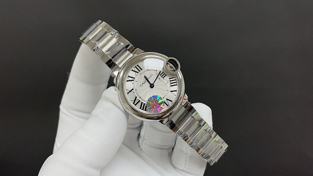 Cartier wristwatch angled view with metal bracelet and round bezel detail
