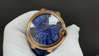 Cartier wristwatch front view with blue dial, Roman numerals, rose gold case