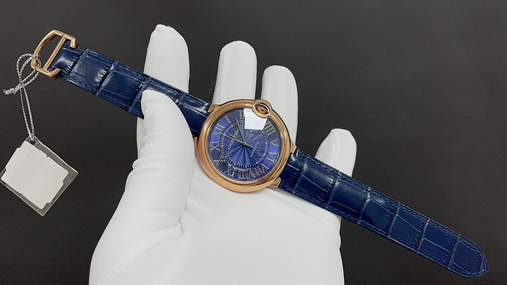 Cartier wristwatch on blue leather strap with buckle, showing hanging tag(s)