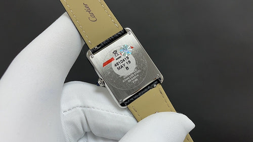 Cartier watch with beige leather strap, stainless case back with date-style sticker