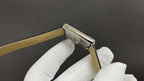 Cartier watch with beige leather strap, side view of rectangular stainless case