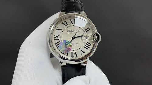 Cartier automatic wristwatch with black leather strap and Roman numeral dial, front view.