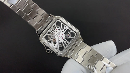 Cartier skeleton dial watch with steel link bracelet, angled view