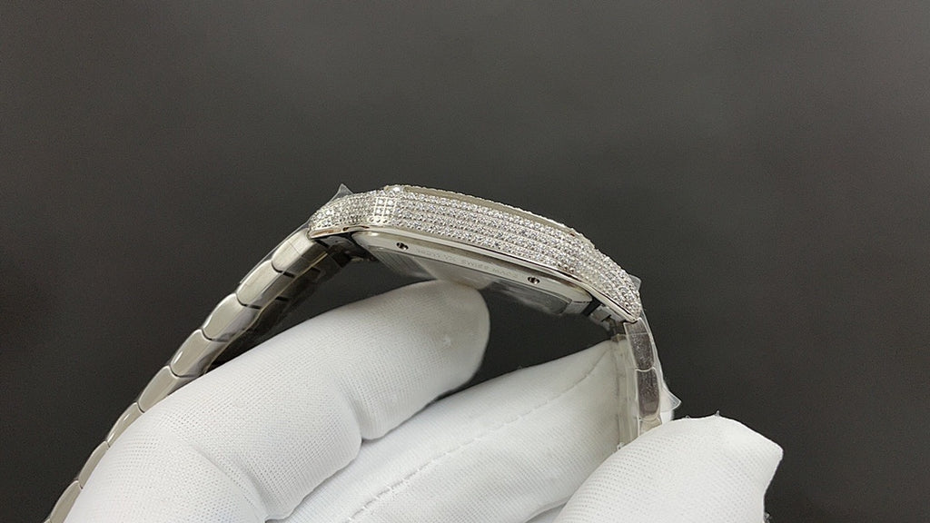 Cartier watch case side with diamond bezel and steel crown on glove