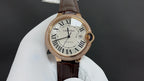 Cartier watch with gold-tone round case, Roman numeral dial, dark brown leather strap