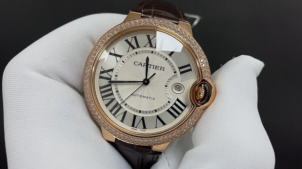 Cartier watch with gold-tone bezel, Roman numeral dial, dark brown leather strap