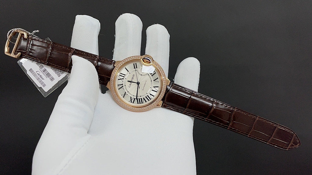Cartier watch with gold-tone case, Roman numeral dial, dark brown leather strap and buckle