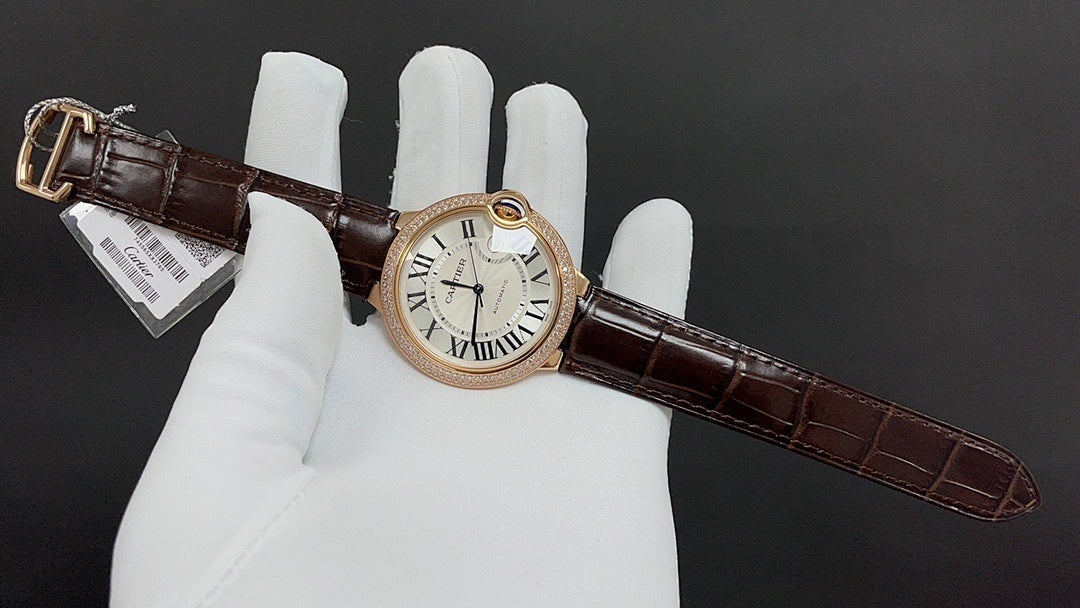 Cartier watch with gold-tone case, Roman numeral dial, dark brown leather strap and buckle