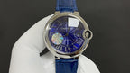 Round wristwatch with blue dial, Roman numerals, and blue leather strap