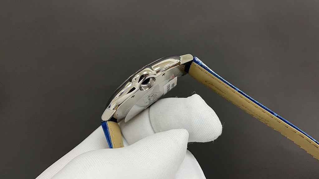 Wristwatch with crown-side stainless case and blue leather strap close-up