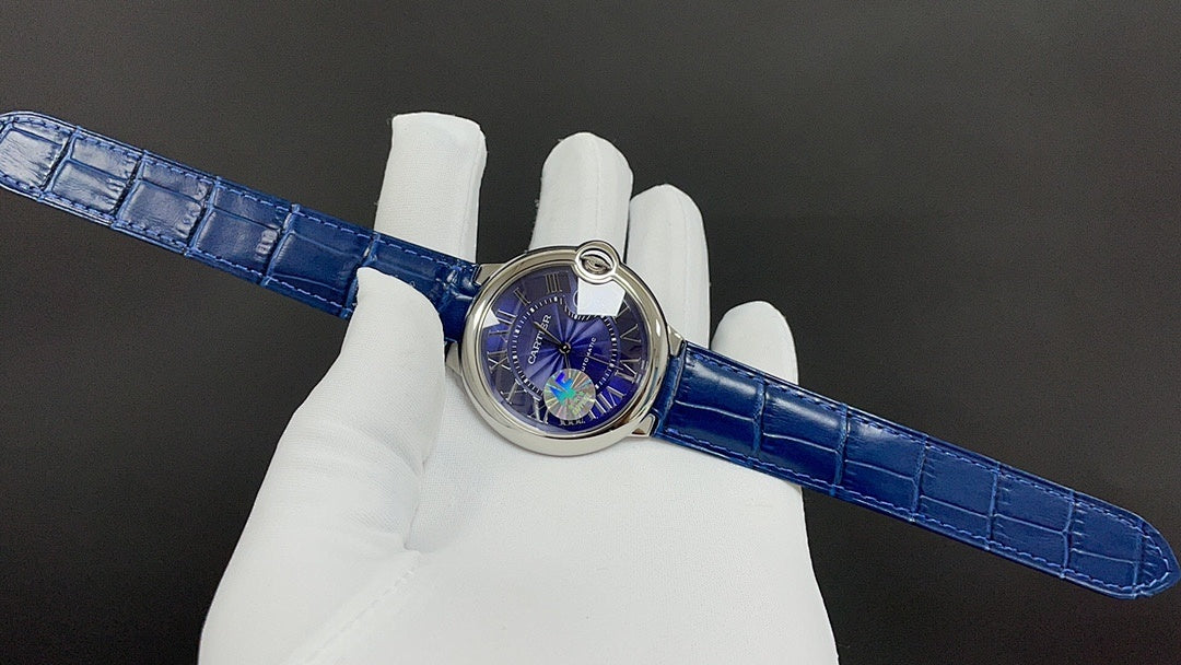 Blue leather strapped wristwatch with circular case and small bezel detail