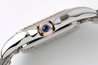Cartier watch crown with blue gemstone, polished case and rose-tone bezel