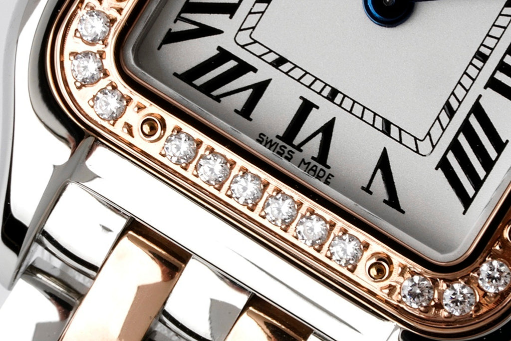 Close-up of Cartier watch bezel with diamond row and Roman numerals dial