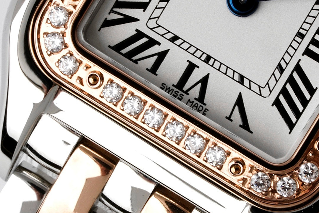 Close-up of Cartier watch bezel with diamond row and Roman numerals dial