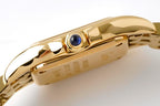 Gold-tone Cartier watch crown with blue gem and polished case edge