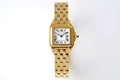 Gold-tone Cartier Tank watch with rectangular case and metal link bracelet