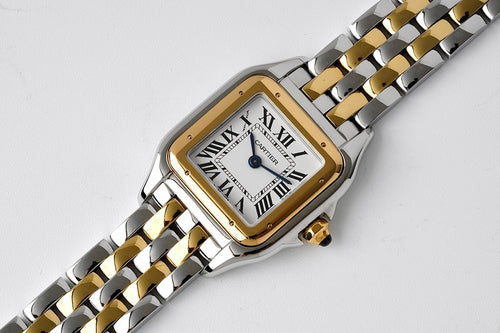 Cartier watch on linked bracelet, gold bezel over white dial with Roman numerals