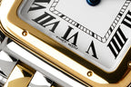 Cartier watch dial close-up with Roman numerals and gold bezel edge