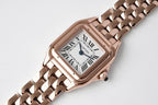 Cartier watch rose gold-tone case with rectangular dial and linked metal bracelet.