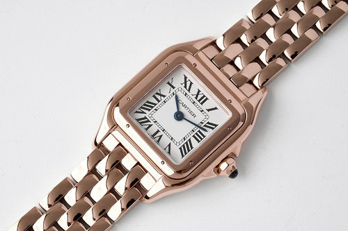Cartier watch rose gold-tone case with rectangular dial and linked metal bracelet.