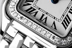Cartier watch close-up of diamond bezel and Roman numeral dial markers
