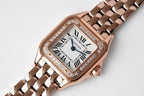 Cartier rose gold watch face with diamond bezel, roman numerals, and linked bracelet