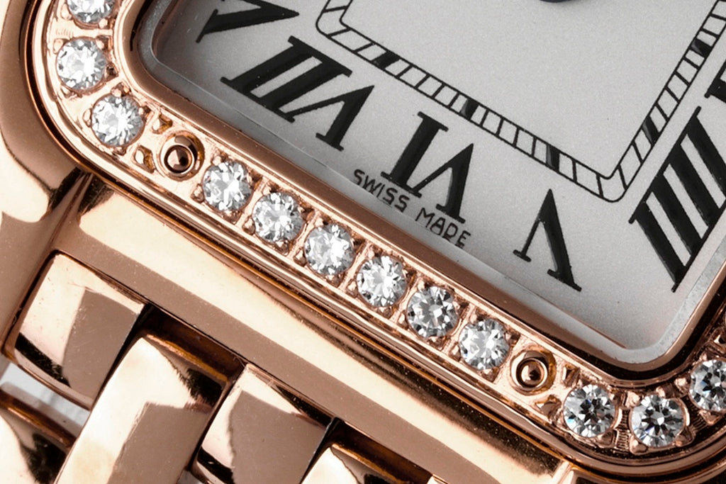 Diamond-set watch bezel along the case edge with roman numeral dial background