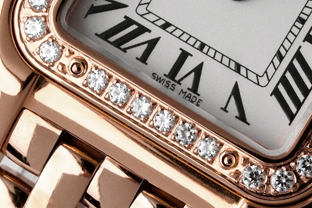 Diamond-set watch bezel along the case edge with roman numeral dial background
