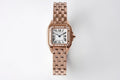 Cartier rose gold watch with diamond bezel, roman numeral dial, and metal bracelet