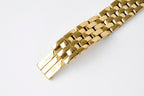 Gold-tone watch bracelet end with clasp and bar hardware on linked links