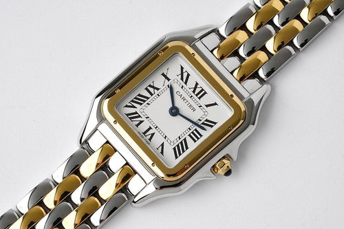 Cartier two-tone wristwatch with rectangular case, Roman numerals, and blue hands