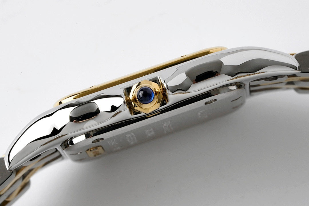 Cartier wristwatch crown area with blue gem accent on polished steel case