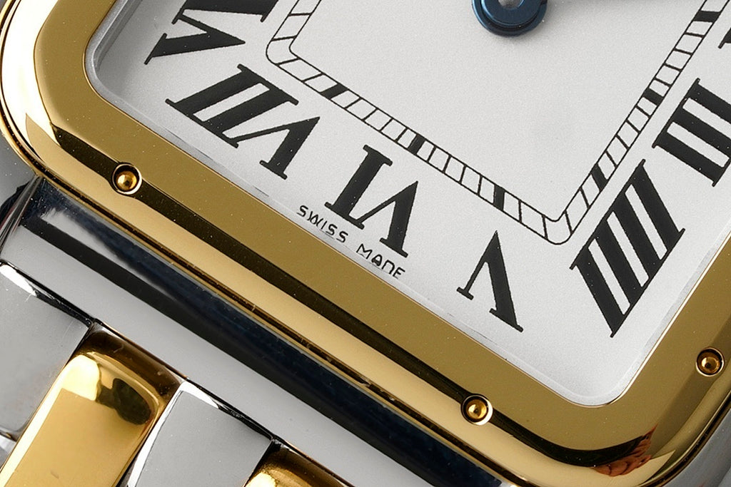 Cartier watch dial close-up with Roman numerals and gold-toned bezel