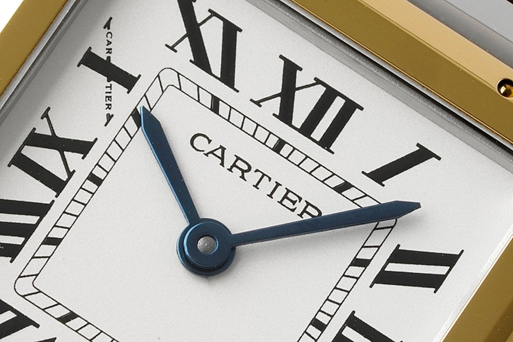 Cartier dial close-up with Cartier name, Roman numerals, and blue hands