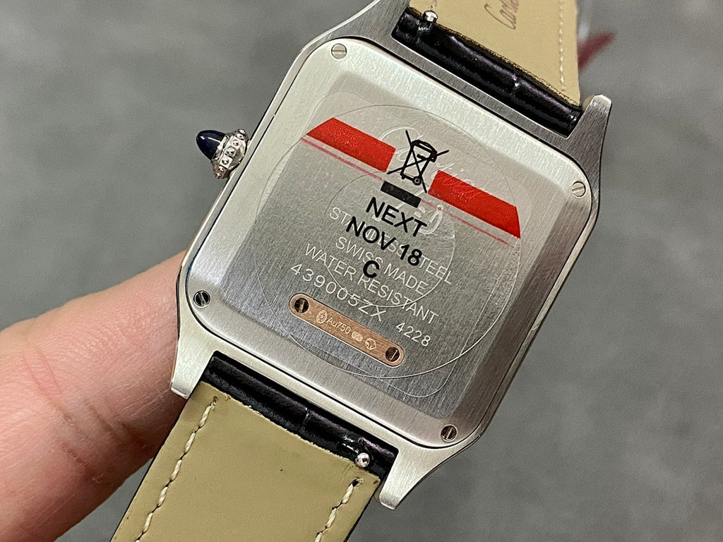 Cartier wristwatch back plate with protective sticker, black leather strap